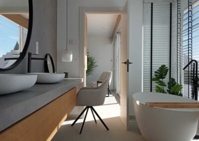 Baño minimalista con bañera. En tonos blanco, madera, negro y gris.